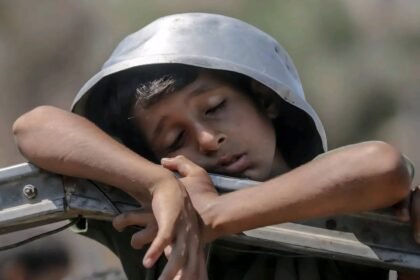 Seorang anak yang tertidur dalam antrian kelaparan, mengambil panci sebagai helm... untuk memimpikan sepotong makanan yang rasanya belum pernah ia ketahui, 27 Juli 2025. (Journalist Ali Abu Aqa/HO/MP)