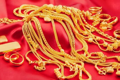 Deretan perhiasan emas dan logam mulia dipajang di atas kain merah. Lonjakan harga emas global ikut mengerek harga emas Antam di Indonesia hingga menembus rekor Rp2.086.000 per gram.