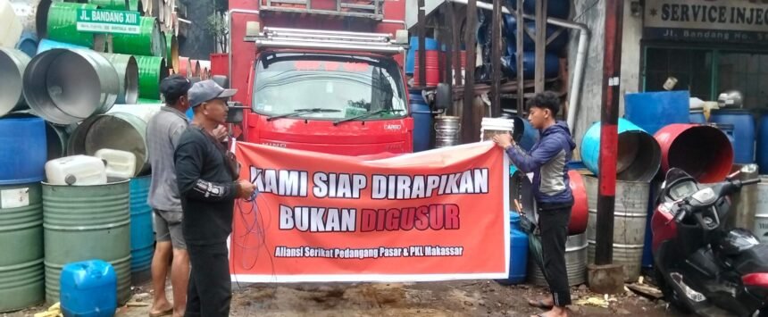 Pedagang drum di Jalan Bandang–Lamuru, Makassar, membentangkan spanduk bertuliskan “Kami siap dirapikan, bukan digusur” saat menyuarakan penolakan terhadap rencana penertiban.